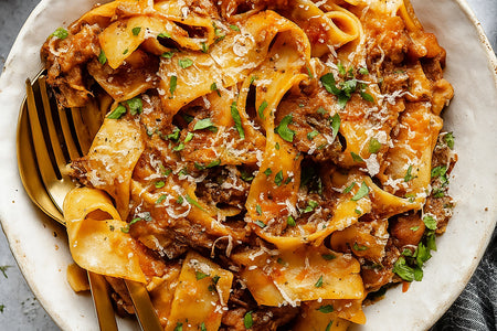 Pasta dish with a fork on a white plate